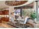 Charming dining area with large windows, custom cabinetry, and an elegant chandelier, seamlessly blending indoor and outdoor spaces at 41667 N 113Th Pl, Scottsdale, AZ 85262