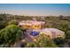 Expansive desert home featuring a private pool, outdoor seating, lush greenery, and unique architecture at 41667 N 113Th Pl, Scottsdale, AZ 85262