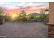 Paver driveway and desert landscaping highlight this home against a colorful sunset at 41667 N 113Th Pl, Scottsdale, AZ 85262