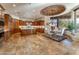 Open-concept kitchen with island, dining area, and a brick accent overhead lighting feature at 41667 N 113Th Pl, Scottsdale, AZ 85262