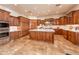 Spacious kitchen with custom wood cabinets, marble countertops, and stainless steel appliances at 41667 N 113Th Pl, Scottsdale, AZ 85262
