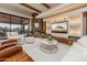 Comfortable living room with stone fireplace and entertainment center at 41667 N 113Th Pl, Scottsdale, AZ 85262