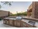 Complete outdoor kitchen with stainless steel appliances and ample counter space, perfect for cooking and enjoying meals outdoors at 41667 N 113Th Pl, Scottsdale, AZ 85262