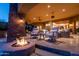 Outdoor living space with fireplace, comfortable seating, and a view of the home's interior at 41667 N 113Th Pl, Scottsdale, AZ 85262