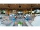Covered patio with ceiling fans, multiple seating areas, and views of surrounding desert at 41667 N 113Th Pl, Scottsdale, AZ 85262