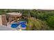 This backyard features a pool and spa with desert landscaping and stone accents at 41667 N 113Th Pl, Scottsdale, AZ 85262