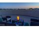 Relaxing rooftop patio with comfortable seating and stunning city views at dusk at 41667 N 113Th Pl, Scottsdale, AZ 85262