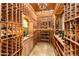Custom wine cellar featuring extensive wood shelving and tile floor at 41667 N 113Th Pl, Scottsdale, AZ 85262