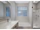 Bright bathroom featuring a glass block window, modern vanity, and glass enclosed shower at 43690 W Knauss Dr, Maricopa, AZ 85138