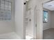 This bath features a glass shower, glass block window, and tile flooring at 43690 W Knauss Dr, Maricopa, AZ 85138