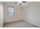 Bright bedroom featuring neutral walls, carpet, and a window at 43690 W Knauss Dr, Maricopa, AZ 85138