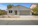 Charming single-story home with a two-car garage and low maintenance desert landscaping at 43690 W Knauss Dr, Maricopa, AZ 85138