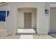 Inviting covered front porch with a security screen door, decorative rocks, and neutral paint at 43690 W Knauss Dr, Maricopa, AZ 85138