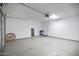 Spacious garage with an automatic door and high ceilings, offering ample storage and parking at 43690 W Knauss Dr, Maricopa, AZ 85138