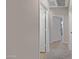 Neutral hallway featuring grey-tone walls, white doors, and neutral carpet at 43690 W Knauss Dr, Maricopa, AZ 85138