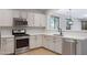 Kitchen showcasing stainless steel appliances, white cabinets, and white countertops at 43690 W Knauss Dr, Maricopa, AZ 85138