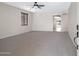 Bright and spacious living room features neutral carpet, arched doorways, and natural light at 43690 W Knauss Dr, Maricopa, AZ 85138