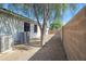 The side yard has decorative rock for drought tolerant landscaping, a tree for shade, and AC unit at 43690 W Knauss Dr, Maricopa, AZ 85138