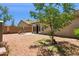Well-maintained backyard with a patio, lush greenery, and shade, creating a relaxing outdoor space at 45042 W Cypress Ln, Maricopa, AZ 85139