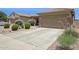 Single-story home featuring desert landscaping, a two-car garage, and neutral stucco exterior at 45042 W Cypress Ln, Maricopa, AZ 85139