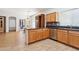 Spacious kitchen with bar seating area, tile flooring and stainless appliances at 45042 W Cypress Ln, Maricopa, AZ 85139