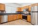 Well-lit kitchen featuring stainless steel appliances and granite countertops at 45042 W Cypress Ln, Maricopa, AZ 85139