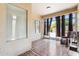 Enclosed sun room featuring tile floors, natural light, and sliding glass doors for seamless indoor-outdoor living at 45042 W Cypress Ln, Maricopa, AZ 85139