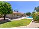 Expansive backyard with a sparkling pool, mature landscaping, and a covered patio perfect for outdoor entertaining at 4532 E Sandra Ter, Phoenix, AZ 85032