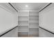 Walk-in closet featuring white shelving and black hanging rods for optimal storage at 4532 E Sandra Ter, Phoenix, AZ 85032