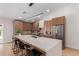 Modern kitchen featuring a large island with seating, stainless steel appliances, and wood cabinetry at 4532 E Sandra Ter, Phoenix, AZ 85032