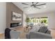 Bright living room featuring modern fireplace, accent wall, and sliding door to a private swimming pool at 4532 E Sandra Ter, Phoenix, AZ 85032