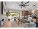Open-concept living area with modern finishes including a fireplace, ceiling fan, and a view of the modern kitchen at 4532 E Sandra Ter, Phoenix, AZ 85032