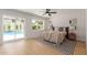 Bright main bedroom with wood floors, ceiling fan, and backyard pool access at 4532 E Sandra Ter, Phoenix, AZ 85032