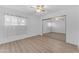 Bright bedroom featuring hard surface floors, fan, and a mirrored closet at 461 W Holmes Ave # 180, Mesa, AZ 85210