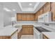 An updated kitchen with new appliances, white countertops, and wooden cabinets at 461 W Holmes Ave # 180, Mesa, AZ 85210