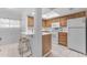 An updated kitchen with white countertops, wood cabinets, and stainless steel appliances at 461 W Holmes Ave # 180, Mesa, AZ 85210
