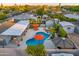 Aerial view showcases a backyard oasis with a pool, spa, lounging area, and lush landscaping at 4610 N 14Th Ave, Phoenix, AZ 85013