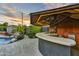 Inviting backyard bar area with custom lighting, sink, and mini fridge, perfect for entertaining guests at 4610 N 14Th Ave, Phoenix, AZ 85013