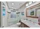 Bathroom featuring a walk-in shower and a vanity with marble countertop and modern mirror at 4610 N 14Th Ave, Phoenix, AZ 85013