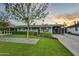 Well-maintained home boasting a green lawn, mature tree, and covered parking, offering curb appeal at 4610 N 14Th Ave, Phoenix, AZ 85013