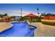Backyard oasis featuring a custom pool, waterfall feature, bar area, and shaded seating at 4610 N 14Th Ave, Phoenix, AZ 85013