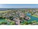 Expansive aerial view of a neighborhood with lakes, mature trees and mountain views at 4700 S Fulton Ranch Blvd # 11, Chandler, AZ 85248