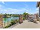Scenic balcony with stone accents and lake view, featuring lounge seating for relaxation at 4700 S Fulton Ranch Blvd # 11, Chandler, AZ 85248
