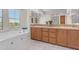 Bathroom featuring double sinks, a mosaic backsplash, wooden cabinets, and a tiled bathtub at 4700 S Fulton Ranch Blvd # 11, Chandler, AZ 85248
