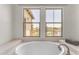 View of a white tiled bathtub with dual windows overlooking the scenic outdoors at 4700 S Fulton Ranch Blvd # 11, Chandler, AZ 85248