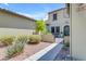 Inviting front yard with a small patio and beautiful desert landscaping leading to the home's entryway at 4700 S Fulton Ranch Blvd # 11, Chandler, AZ 85248