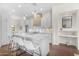 Stylish kitchen with white cabinets, a large island with seating, and elegant pendant lighting at 4700 S Fulton Ranch Blvd # 11, Chandler, AZ 85248