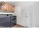 Convenient laundry room equipped with modern washer and dryer units with built-in cabinet storage at 4700 S Fulton Ranch Blvd # 11, Chandler, AZ 85248