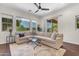 Spacious living room with large windows offering picturesque backyard views and a cozy sectional sofa at 4700 S Fulton Ranch Blvd # 11, Chandler, AZ 85248