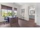 Well-lit home office with a wooden desk, a view to the outside and access to a modern bathroom at 4700 S Fulton Ranch Blvd # 11, Chandler, AZ 85248